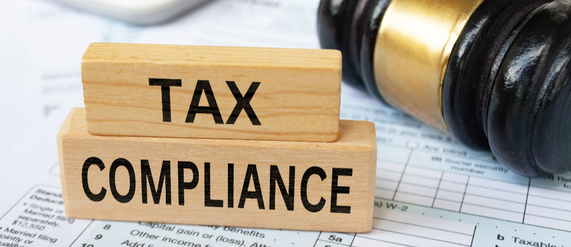 Tax Compliance Text On Wooden Blocks With Tax Form, Gavel And Ca